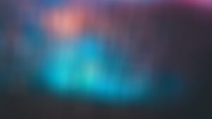a blue and pink blur against a darker background