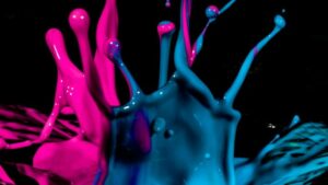 a close up of blue and pink paint splashes