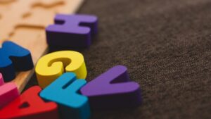 a random selection of brightly coloured letters on a dark backcloth