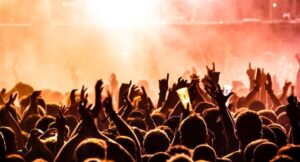 a crowd of people with arms raised