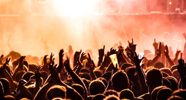 a crowd of people with arms raised