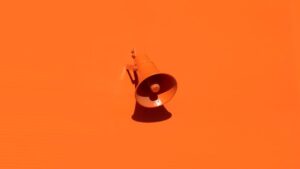 a small orange megaphone set against a similar orange background