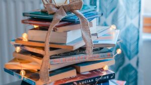 a collection of books with a bow tied on top