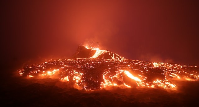 hot red lava flowing down a mountain at night