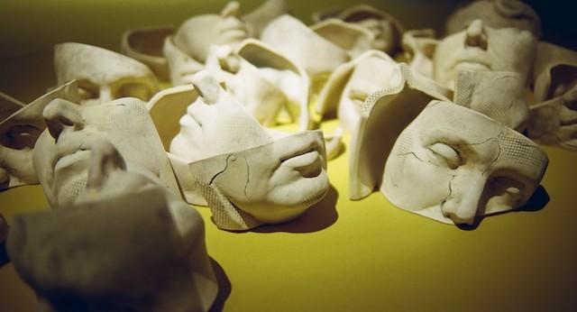 a set of white masks laid out against a lime background