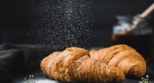 a loaf of bread, appearing to give off molecules of aroma