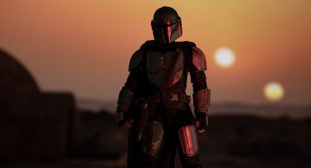 the Mandalorian, if all armour, seen against the background of a setting sun