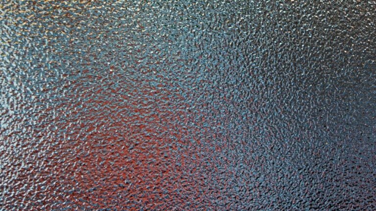 a mottled surface as if seen through glass, with subtle colour shades